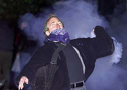 A Protester hurls a gas canister back at the police. Seattle N30.